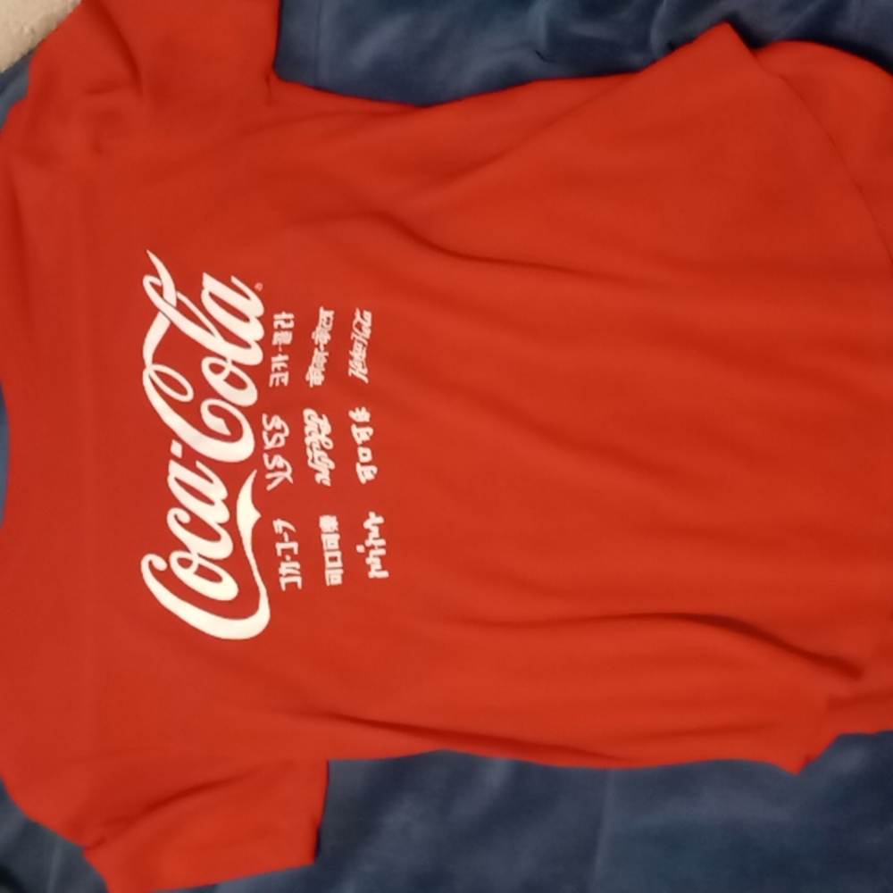 Coca cola shirt.